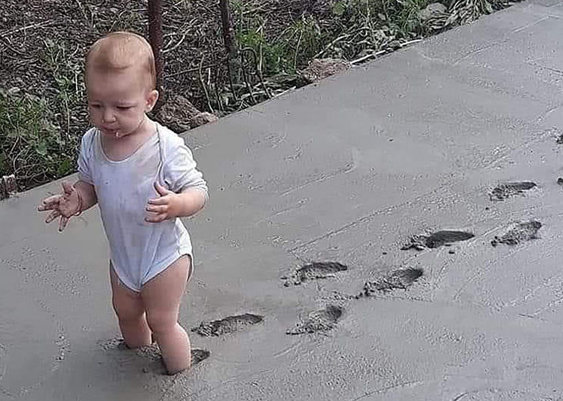A tot comes to a sticky end walking on the concrete path a little too soon