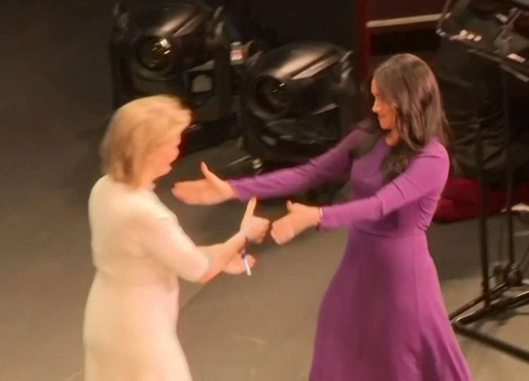 Kate tried to shake Meghan's hand at first