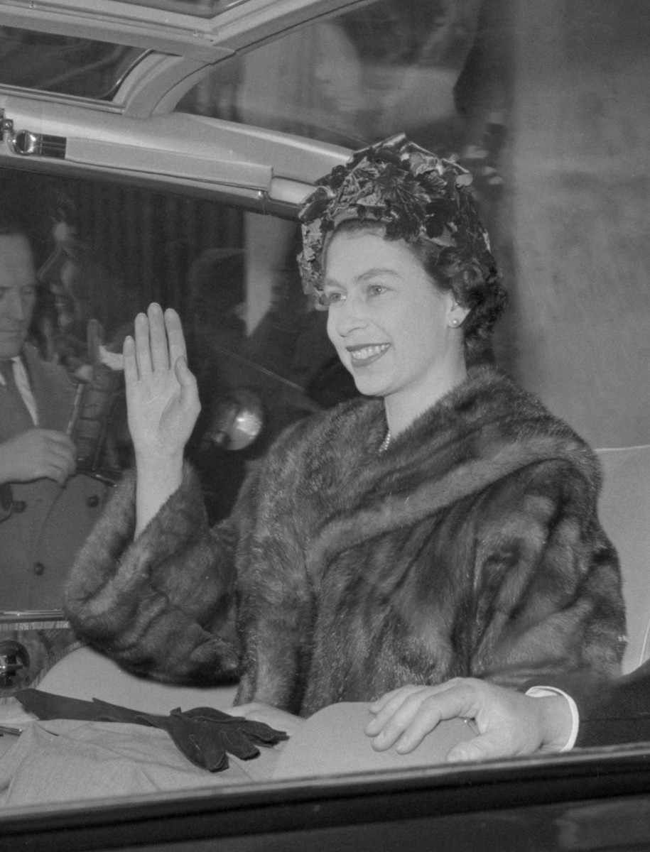 Her Majesty waves to crowds in 1961