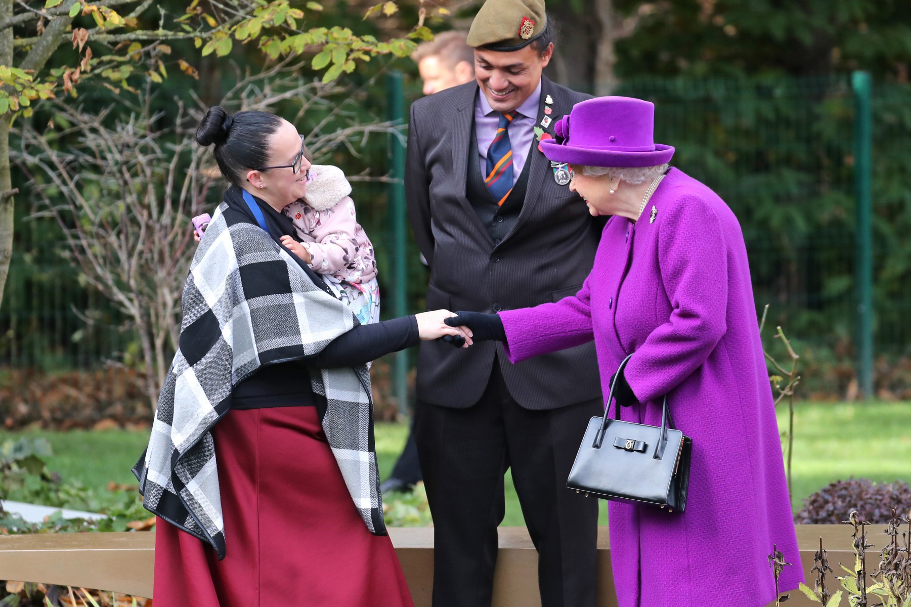 The Queen beams as she meets a veteran's family