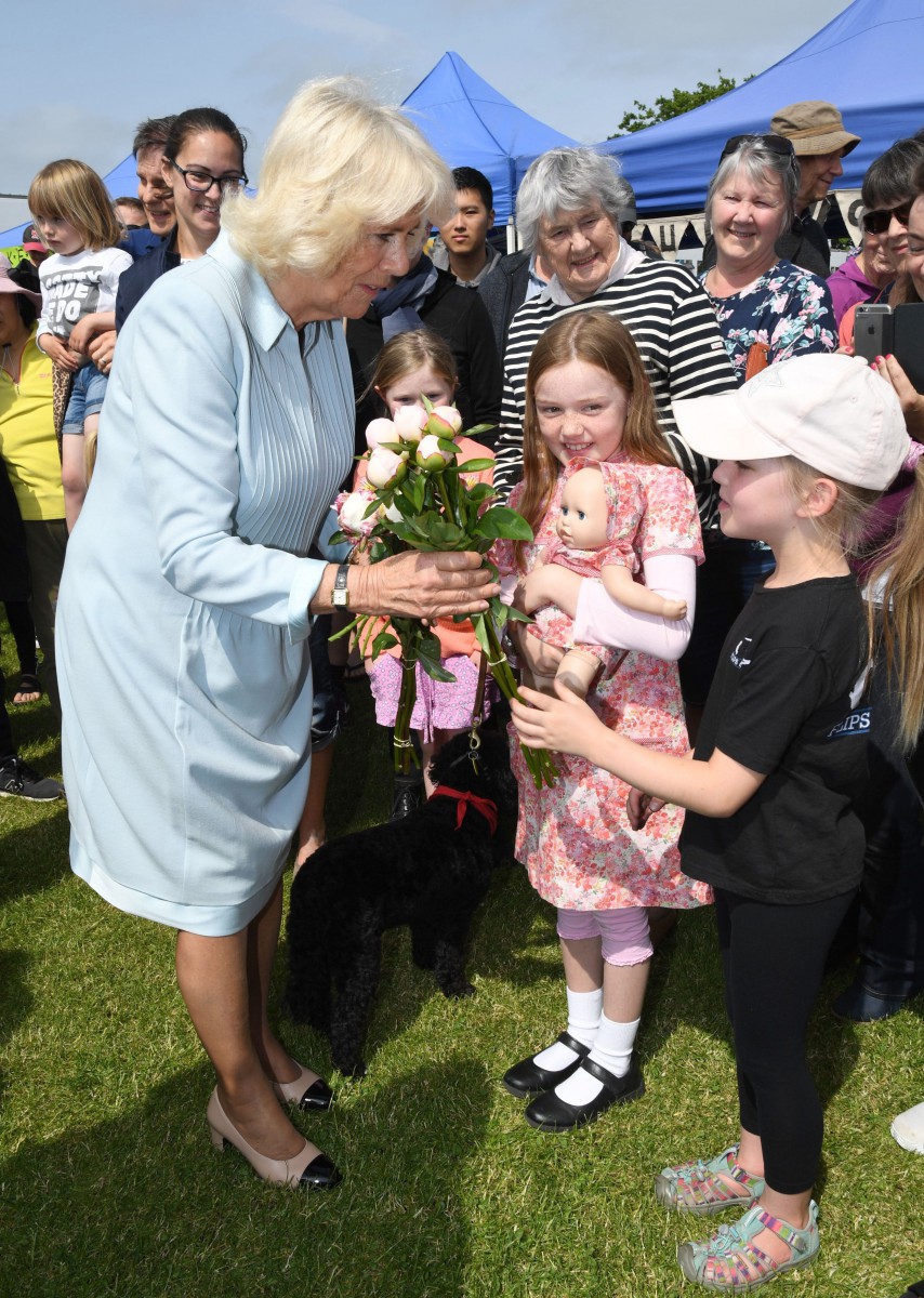 The Duchess of Cornwall is handed flowers