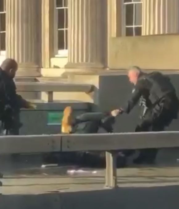 Armed police can be seen detaining a man on London Bridge
