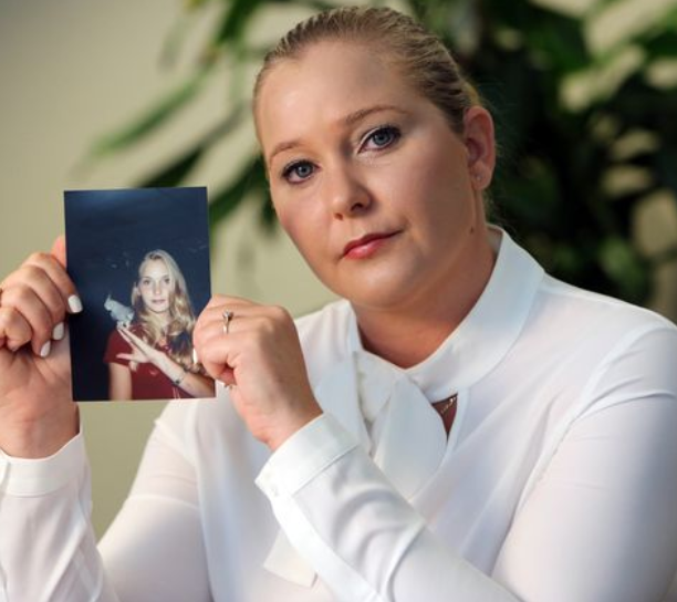 Roberts holding a photograph of her as a teen when she claims she was first targeted by Epstein