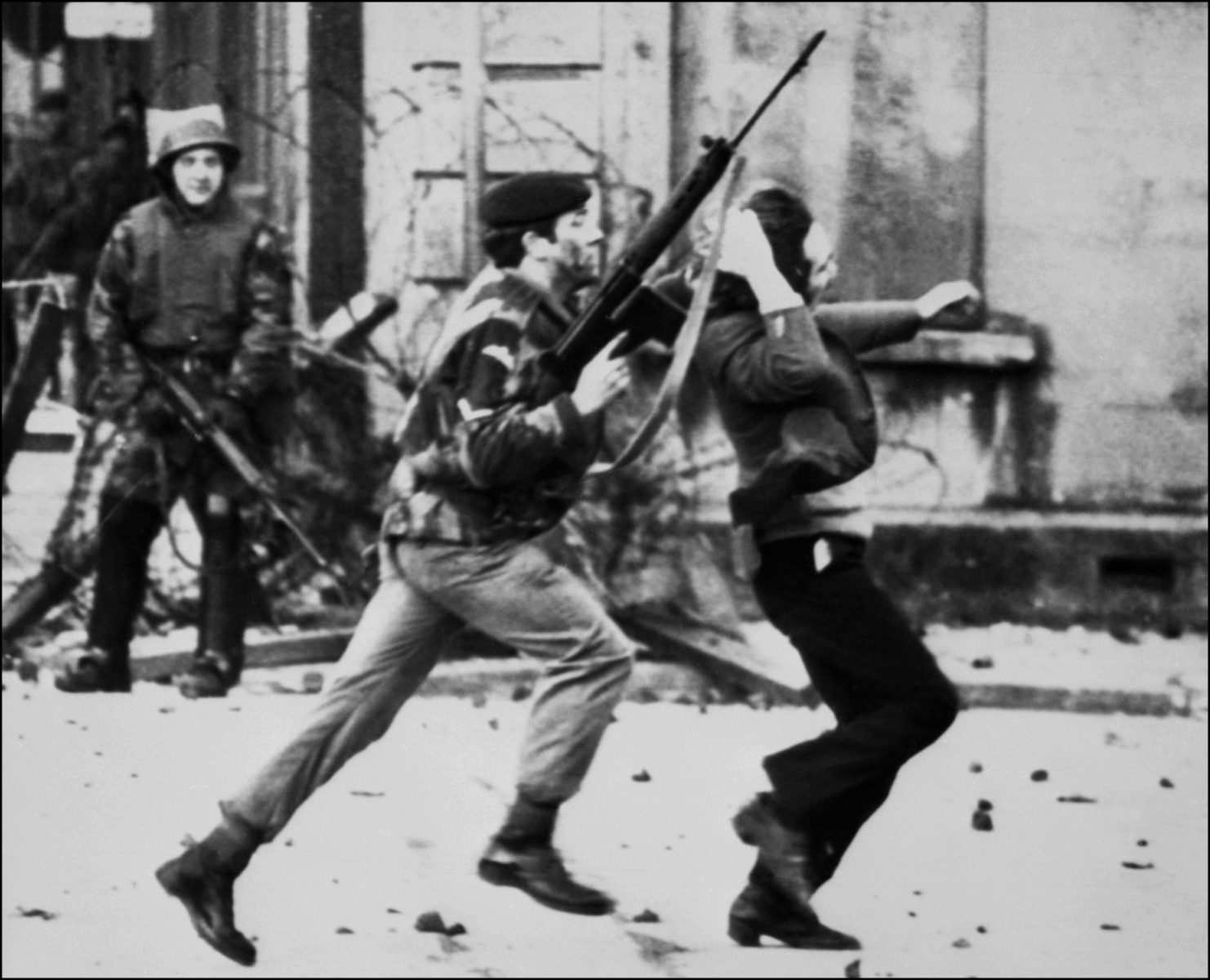 A British paratrooper grabs a captured youth from the crowd on Bloody Sunday