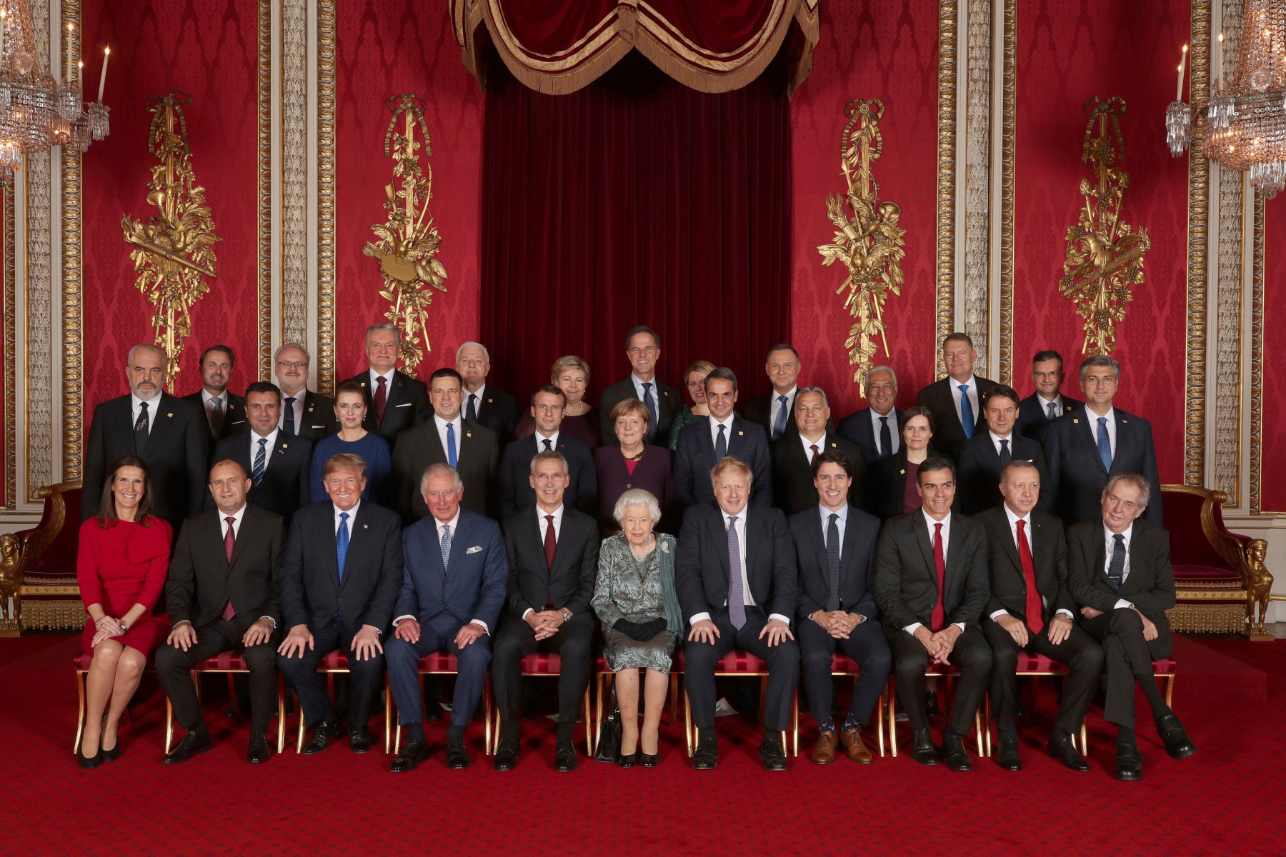 Leaders of NATO alliance countries, and its secretary general, join the Queen and Prince Charles for a group picture during a reception in Buckingham Palace