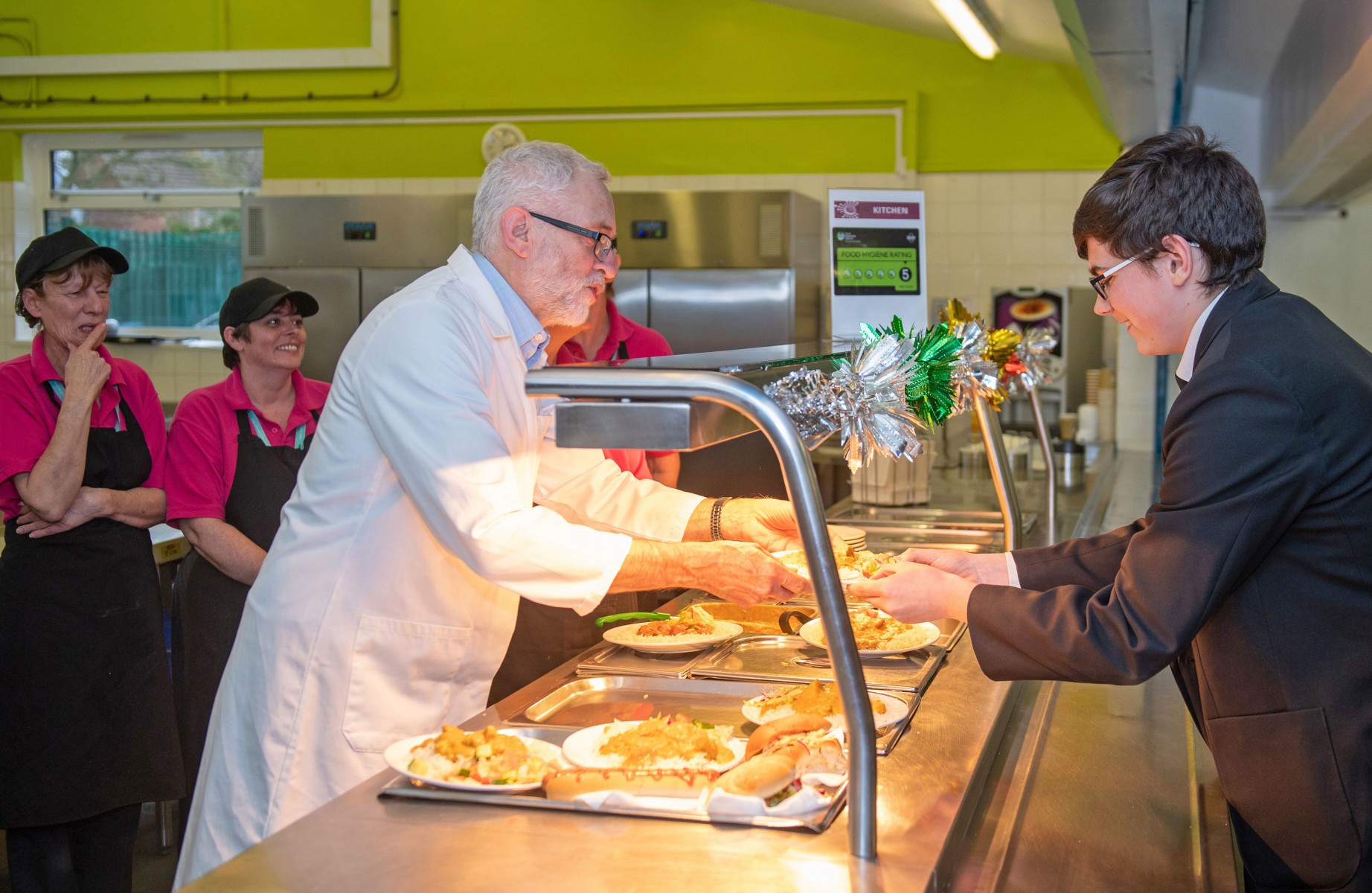 The Labour leader has been serving school dinners at Bilton High School