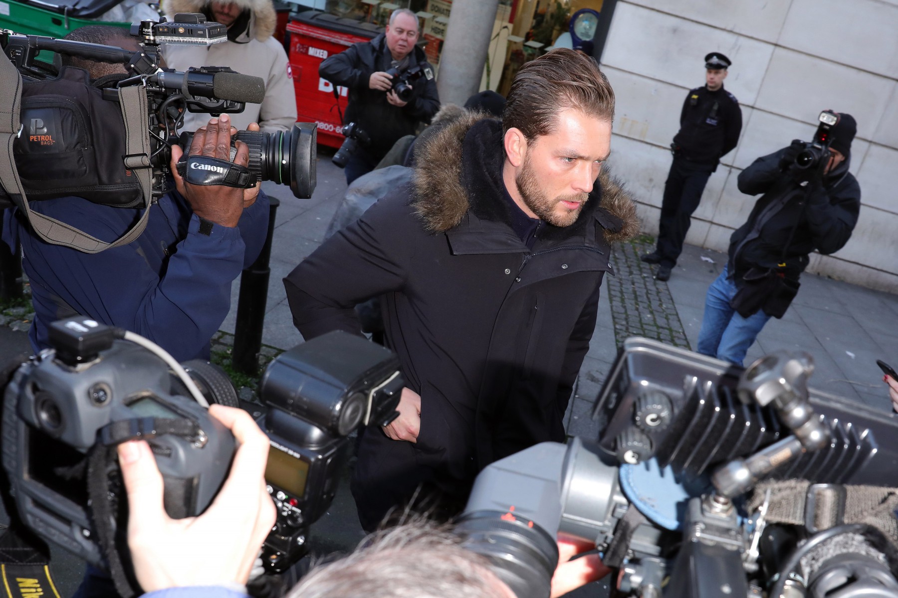 Lewis arrived separately to Ms Flack at court this morning