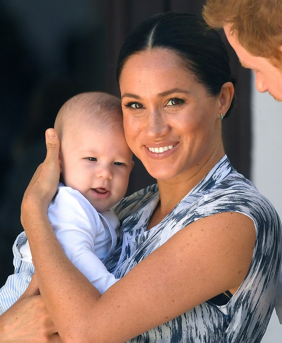 Meghan Markle smiles as she holds baby Archie -who got a cuddle from Hillary Clinton