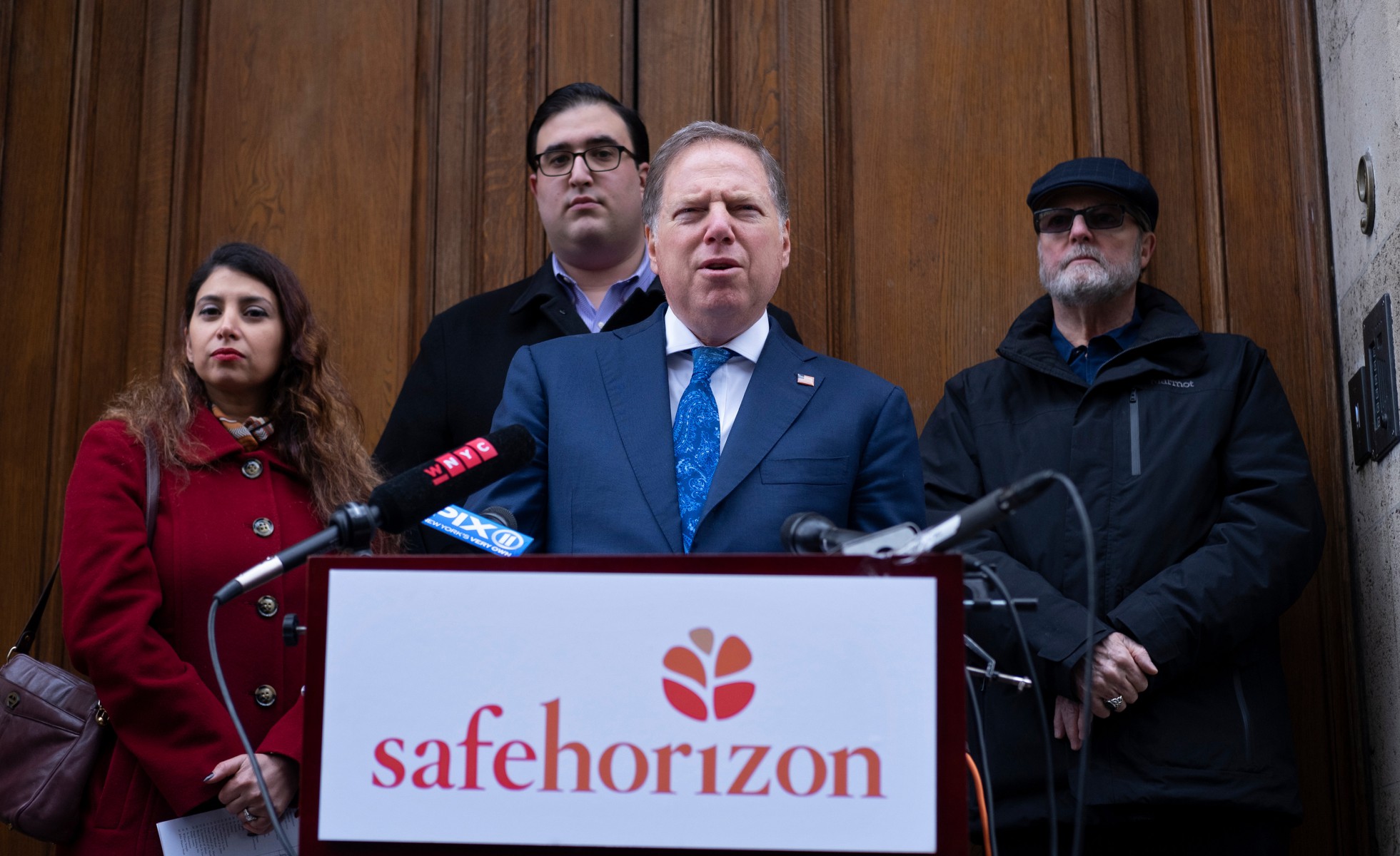 Geoffrey Berman, standing with victims of childhood sexual abuse, speaks at an event held by Safe Horizon, a non-profit victim services agency, in front of Jeffrey Epstein's Manhattan residence