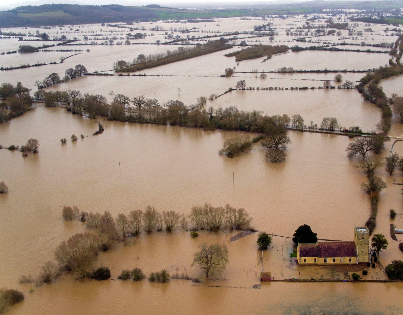 Flood water surrounds a church in Tirley, Gloucestershire