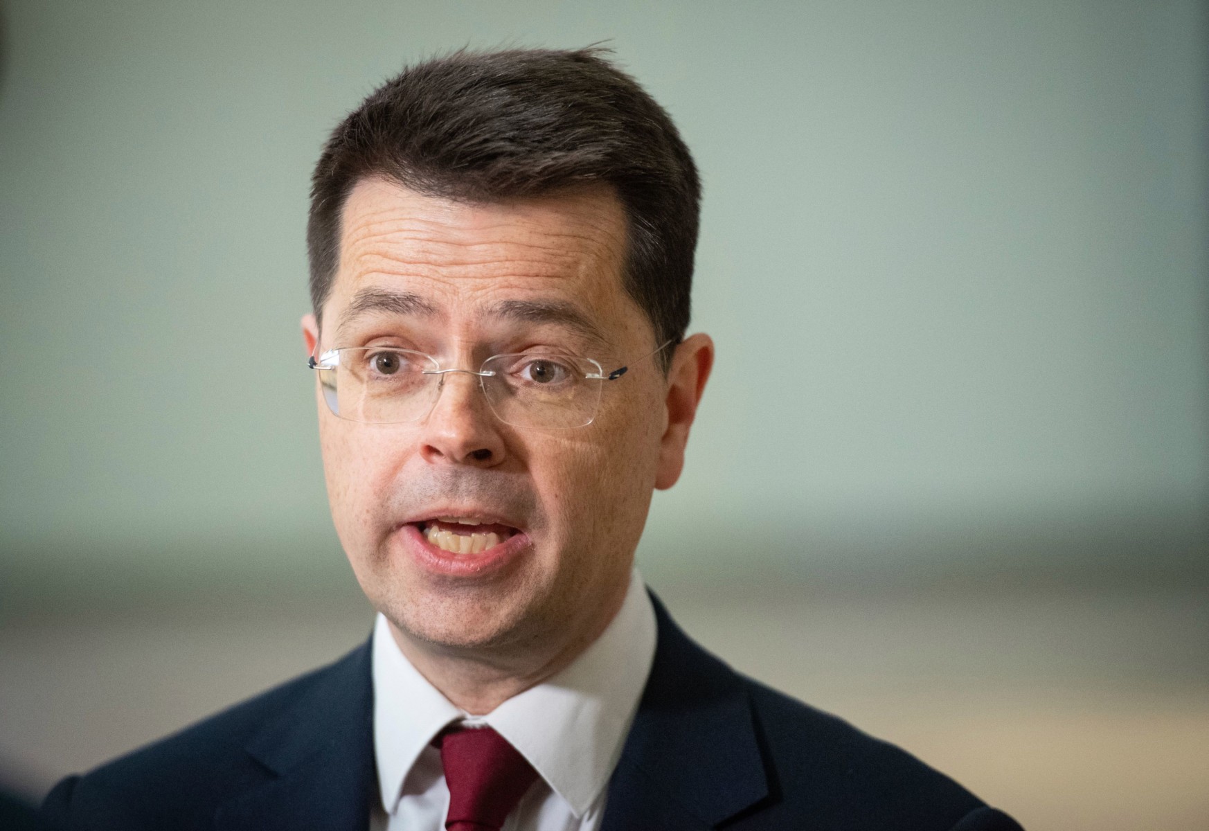 Security Minister James Brokenshire is staying home after attending a spy summit with an Australian MP who has since been tested positive