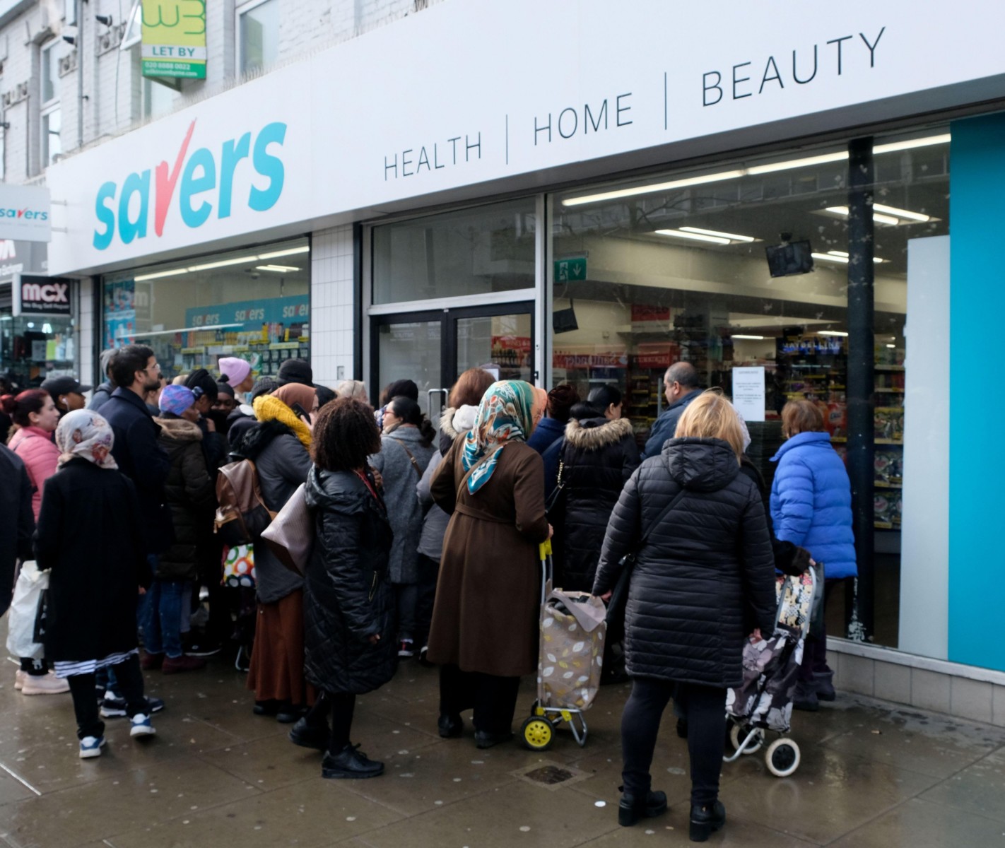 Wood Green, London, UK. 14th March 2020. Coronavirus: people queue to buy toilet paper at a Savers store in Wood Green, north London. Credit: Matthew Chattle/Alamy Live News