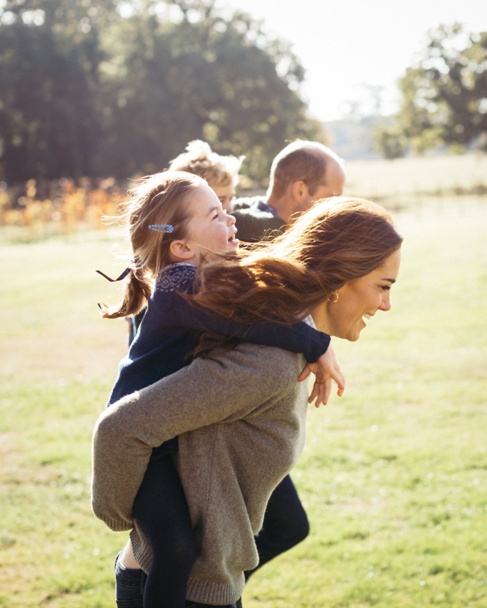 This beautiful family shot of the Cambridges giving piggybacks at Anmer Hall was shared on Mother's Day