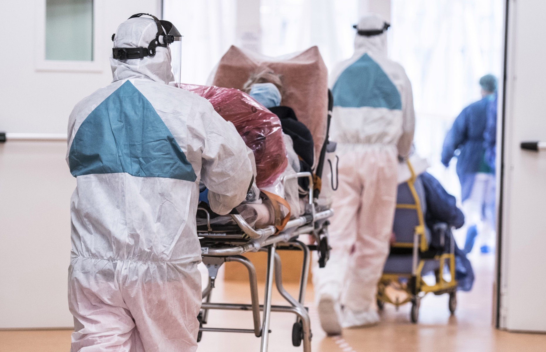 Personal healthcare workers with Personal Protective Equipment (PPE) transport infected Coronavirus (COVID 19) patients at the Verduno Hospital on March 31, 2020 in Turin, Italy