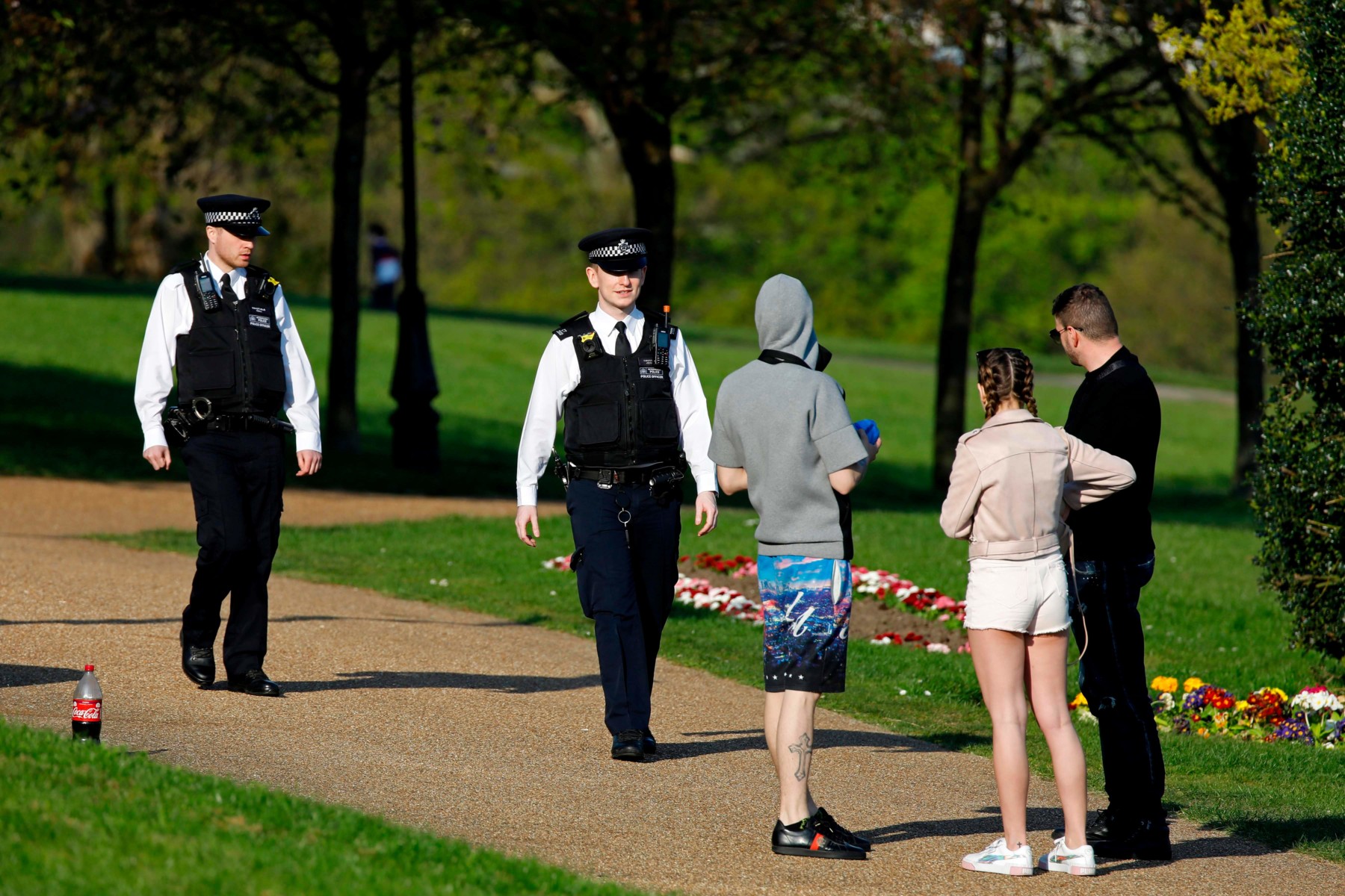 Police officers speak to Londoners in Alexandra Park to remind them of social distancing rules