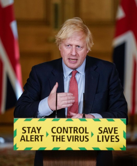 Prime Minister Boris Johnson holding a press conference and standing in front of the 'Stay alert, control the virus, save lives' sign