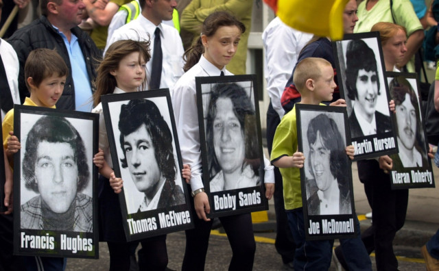 Children carry pictures of the hunger-strikers during a Republican rally to commemorate the 20th anniversary of the IRA hunger-strike at the Maze prison in Northern Ireland