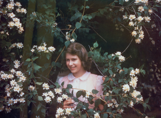 Surrounded by flowers on July 8, 1941, at the age of 15, at Windsor Castle in Berkshire