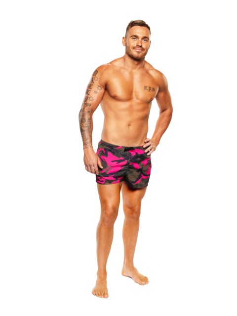 Eden poses in a pair of black and pink swimming shorts 