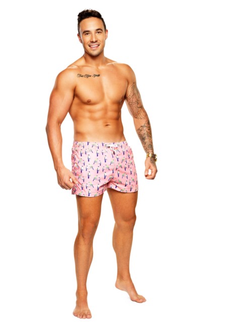 Grant sports a pair of pink swimming shorts and a few tattoos on his arm and chest