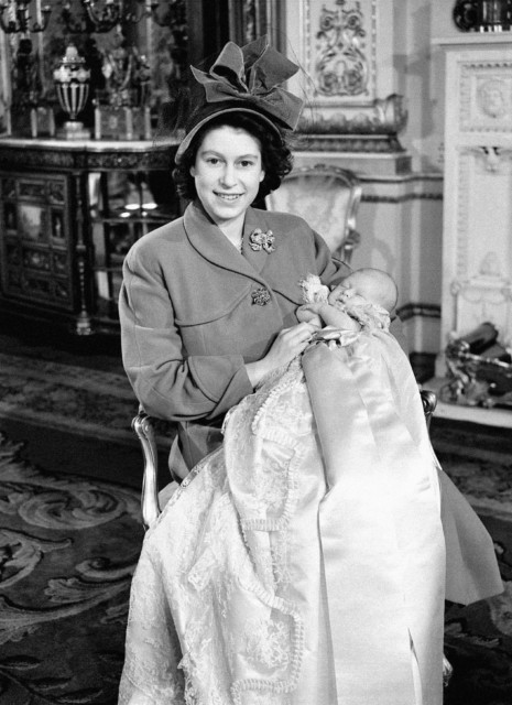 Princess Elizabeth, 22, holding Prince Charles after his christening ceremony at Buckingham Palace, December 15, 1948