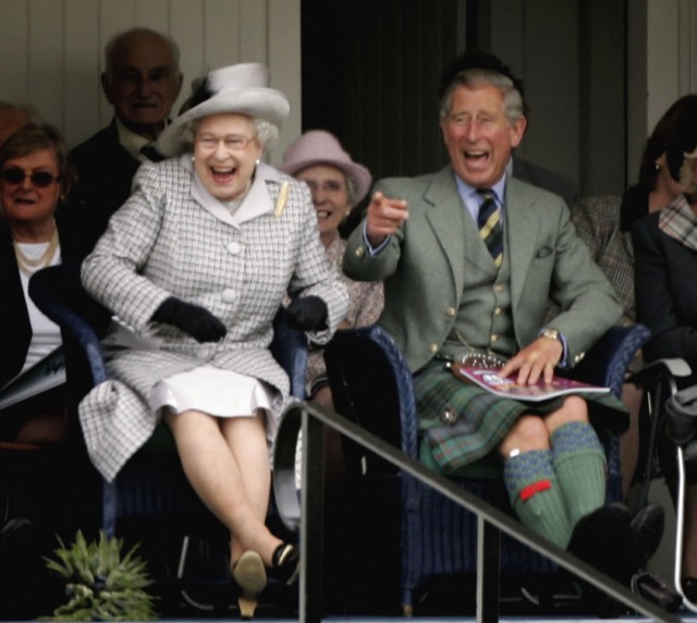 The Queen laughing with Prince Charles as they watch competitors during the Braemar Gathering at the Princess Royal and Duke of Fife Memorial Park on September 2, 2006 in Braemar, Scotland