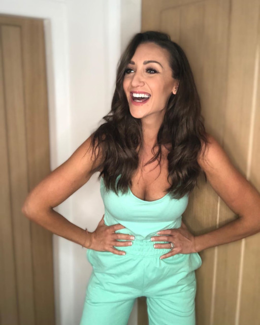 Catherine managed a half-smile while posing in a turquoise dress designed by dancer Saffron Barker