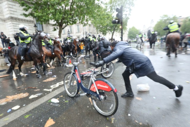 A bike was reportedly hurled at police horses during the protests outside Whitehall