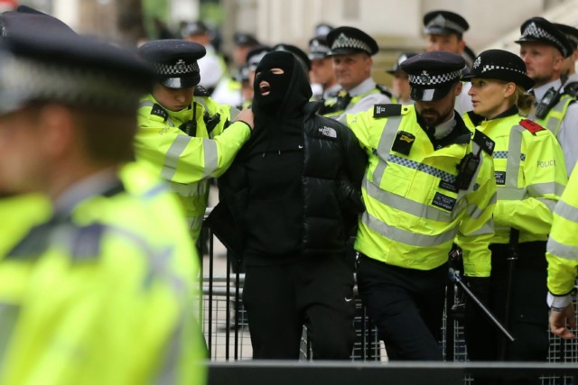 Police arrest a protester during demonstrations in central London
