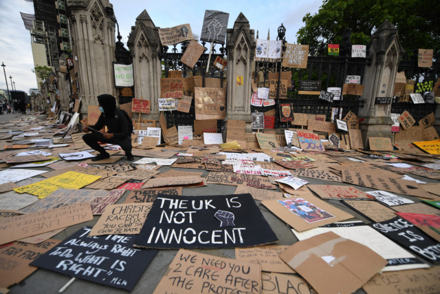 Demonstrators leave their placards outside the Houses of Parliament