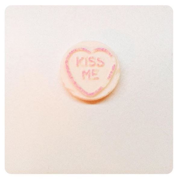 Meghan also hinted at their blossoming relationship by posting a photo of Love Hearts sweets saying "Kiss Me"