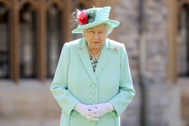 Her Majesty, pictured shortly after the wedding, wore an aqua coloured coat and matching hat adorned with flowers