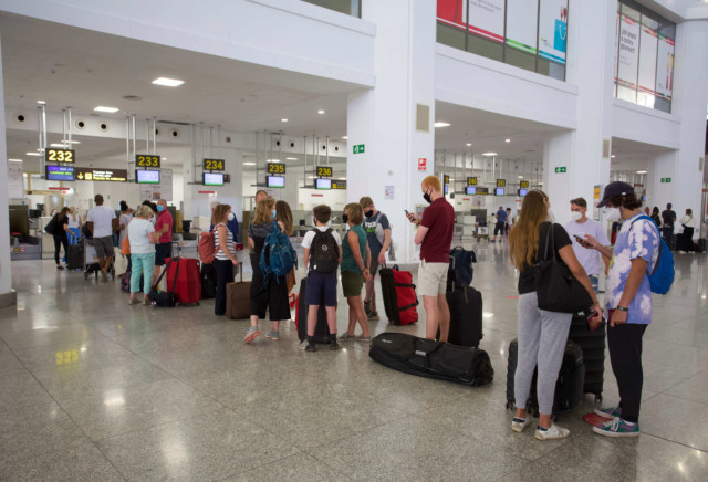 British tourists queue to return home from Malaga airport yesterday