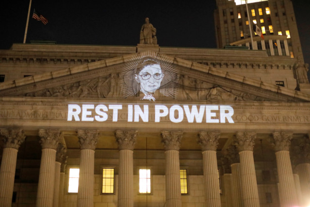 Ruth Bader Ginsburg's image is projected onto the New York State Civil Supreme Court building