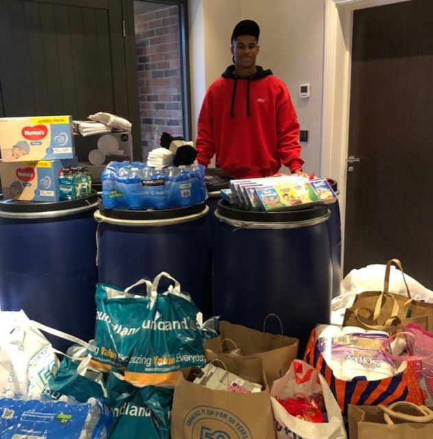  Rashford with shoeboxes full of essential items for the homeless
