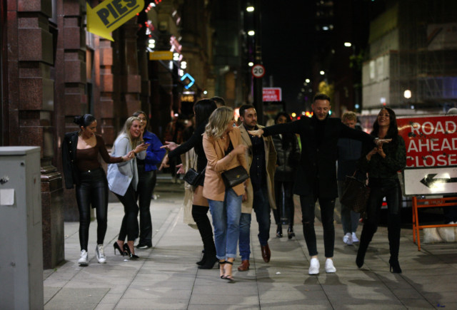 A group of friends walk through Manchester