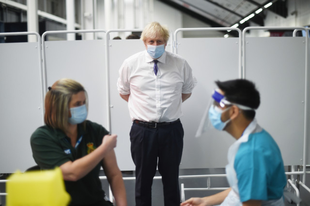 Boris Johnson, seen here at a vaccine centre yesterday, is urging people not to bend lockdown laws