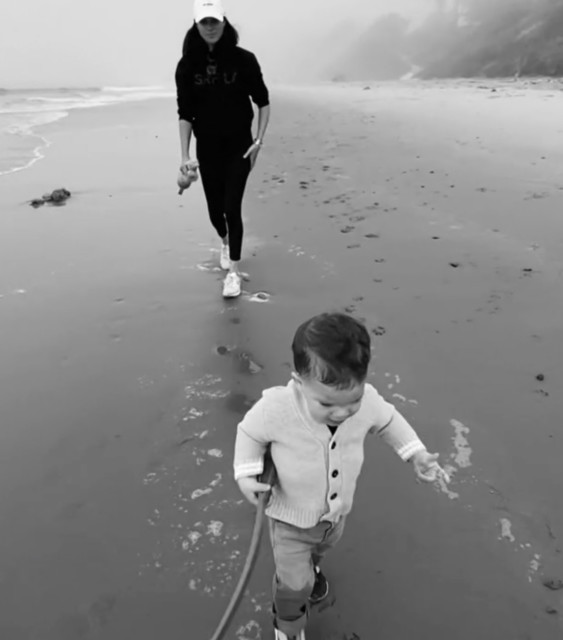 Meghan with Archie on a beach in California