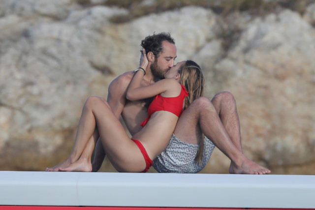 The couple share a passionate kiss while on holidays