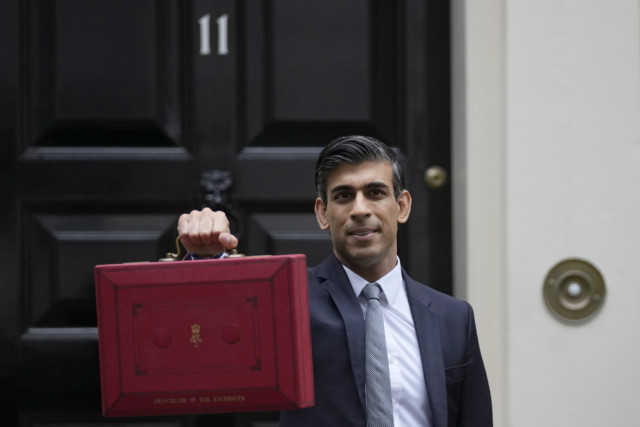 Rishi Sunak holds up his red box with the Budget outside No11 Downing St today