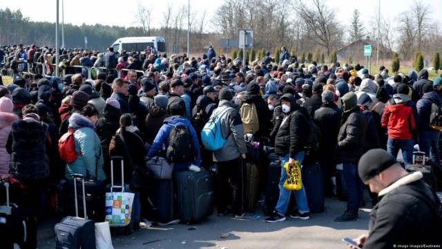 People wait at the border as they try to escape Ukraine