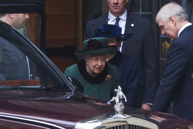 The Queen is taken to her limousine by Andrew after the service